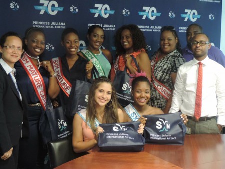 Contestants sponsored by SXM Airport for the Carnival Queen Pageants 2014 pose with SXM staff. L-R: Suzy Kartokromo, Acting Manager, Marketing and Customer Service Dept. (SXM Airport), Anna Rabess-Richardson, newly-crowned Miss Mature Queen, Tamara Groeneveldt (First Runner Up), Bria Sorton (contestant Senior Carnival Queen), Charissa Gumbs (Miss Mature contestant), Michelle Browne (Miss Mature contestant), Michael Granger (President SCDF) and Clifton Brown, Special Projects Manager (SXM). Sitting are left, Juleeza Veldkamp (Teen Queen contestant) and D’shnay York (Teen Queen contestant). (SXM photo)
