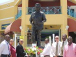 CEO Mark Mingo (3rd from left), Hector Peters (4th from left) laying the wreath in front of the Dr. A.C. Wathey statue at the port in the presence of port staff