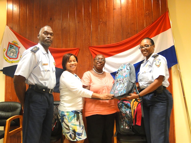 From L to R. C.P.O. Steven Carty, vice pres. of the Rotary Club of Sint Maarten Sunrise Mrs. Joseanne Peterson, Mrs. Rachel Martenborough  of the Crystal Home and the C.P.O. Arcella Leonard during the presentation of the bags at the Philipsburg Police Head quarters.
