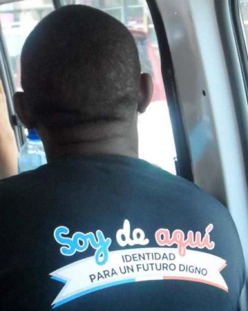 “Soy de aquí …” (“I am from here, Identity for a dignified future.”), man wears t-shirt with a slogan of the citizens rights organization, Reconoci.do, Santo Domingo, 2013