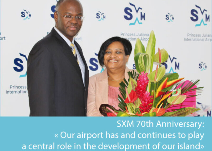 PJIAE. Gov. Holiday Presents LaBega with Bouquet of Flowers on SXM 70th Anniversary