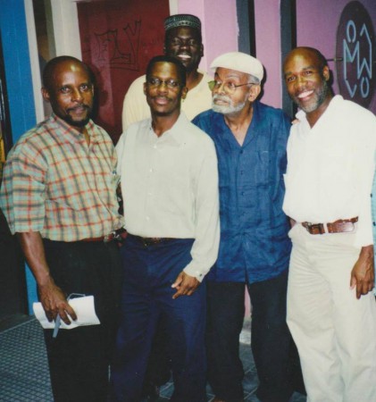Amiri Baraka (2nd R) in St. Martin with pan musician and kaisonian Isidore “Mighty Dow” York (R), political scientist Joseph H. Lake, Jr. (L), author Lasana M. Sekou (2nd L), and poet Changa Hickinson following the HNP Creative Writers Program recital at Philipsburg Jubilee Library, 2003. (File photo courtesy Shujah Reiph)