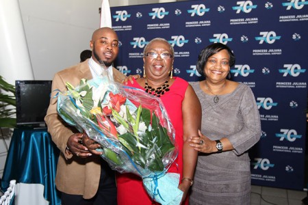 L-R. Kevin Jeffers, the first Jean Christian Aviation Scholar, Ms. Jean Christian (with bouquet of flowers), St. Maarten’s first female Air Traffic Controller, after whom the scholarship is named and SXM Managing Director, Regina LaBega. (SXM photo)