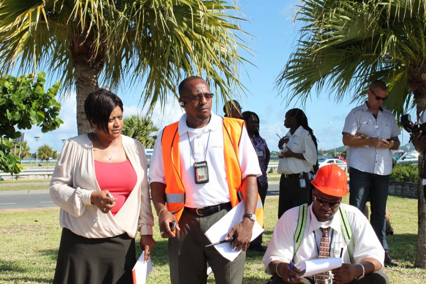 SXM Airport Managing Director Regina LaBega (L) and Manager of Operations Michel Hyman (2nd L) outside of airport building during previous evacuation drill. (SXM photo)