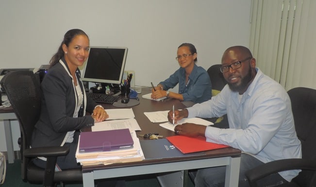 (L-R) Sandy Offringa, SXM Legal Officer, Suzy Kartokromo, Acting Manager of Marketing & Customer Service, and Cleon Frederick, Managing Director of St. Maarten Wrapping Service, at the signing. (SXM photo)