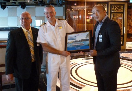 Presentation of the plaque to Regal Princess Captain Edward Perrin (2nd from left) by CEO Mark Mingo (right) in the presence of Supervisory Board Director Renald Williams (left)