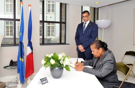Sint Maarten’s Minister Plenipotentiary Hon. Josianne Fleming-Artsen (seated), signing the book of condolence at the French Embassy in The Hague, the Netherlands as Director of the Cabinet of Minister Plenipotentiary Perry Geerlings looks on. Photo Cico van der Ven