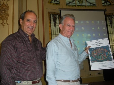 Emilio Jorge Rodríguez, holding the “Este Caribe Nuestro” Award 2014, presented to him in January 2015, by Dr. Antonio Romero (L), president of the Chair of Caribbean Studies, University of Havana. (Photo courtesy EJR)