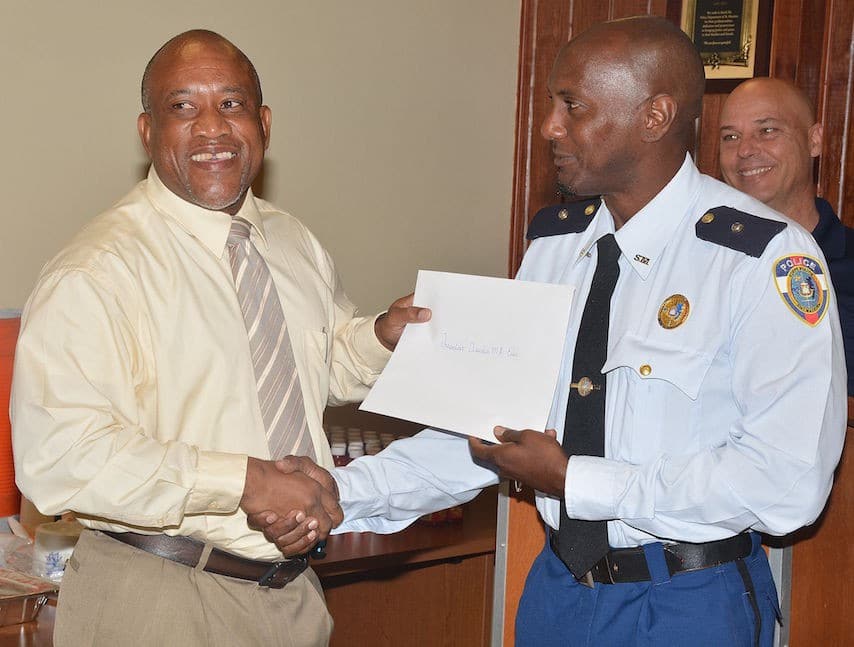 Pic: Inspector Claudio Ellis receives his decree from Comm. Carl John. 