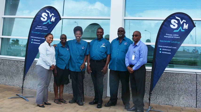 In Photo: ATA Secretary Rohan Romney and President Jean Samuel (center) pose with other ATA members in the new SXM branded uniforms. They are joined by Maggie Gumbs, SXM  Airport Marketing Officer (left) and Larry Donker, SXM Director of Operations (right).