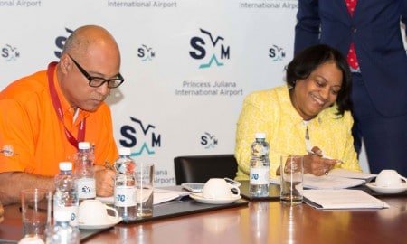 SXM managing director Regina LaBega and TLC managing director, Steve Kong signing the agreement at the Boardroom of SXM Airport Thursday, March 19, 2015